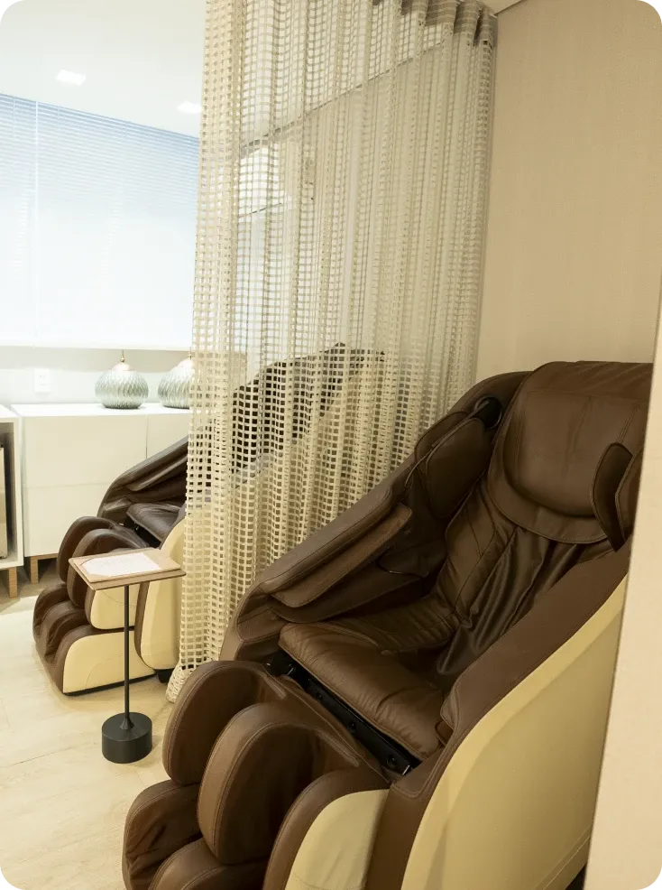 Espaço de relaxamento da clínica com poltronas de massagem